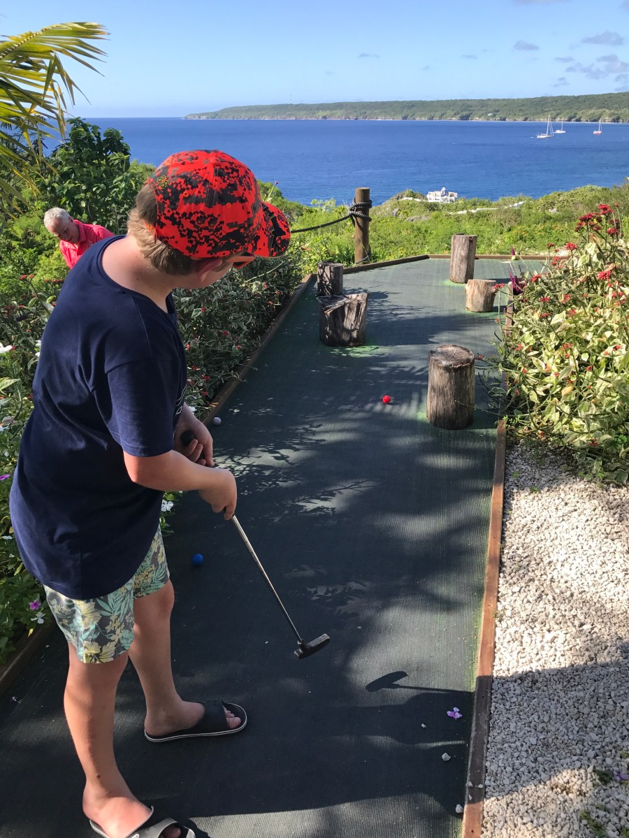 boy playing mini golf in Niue