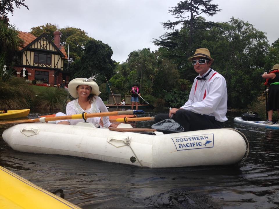woman and a man wearing hats in an inflatable dinghy on the Avon River, Christchurch