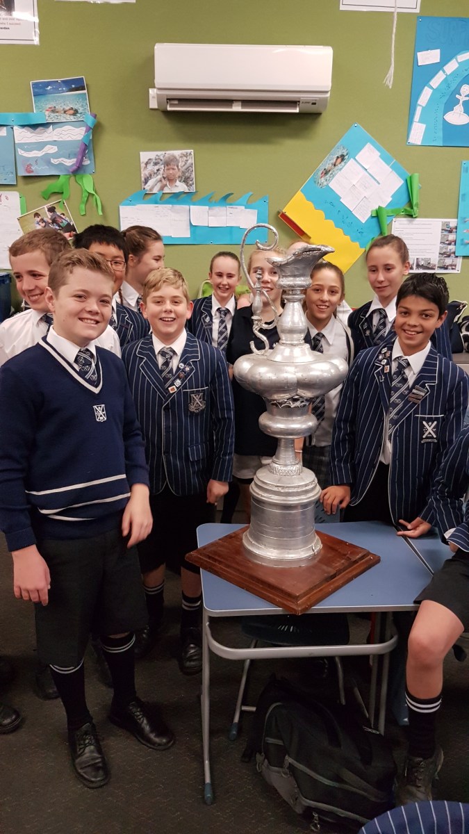 School children from St Andrews College with a replica of the Americas Cup
