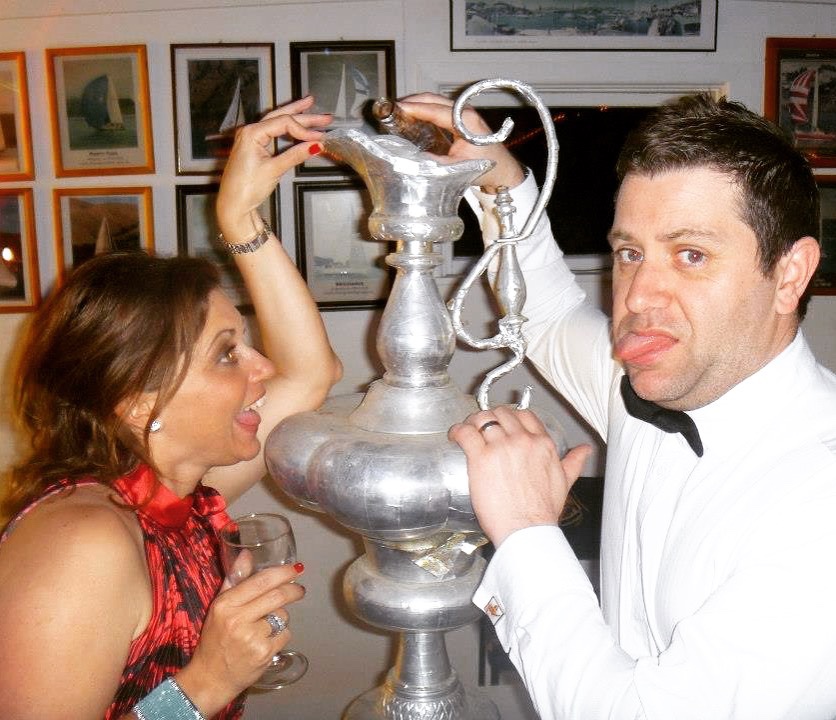 woman and man with a replica of the Americas Cup